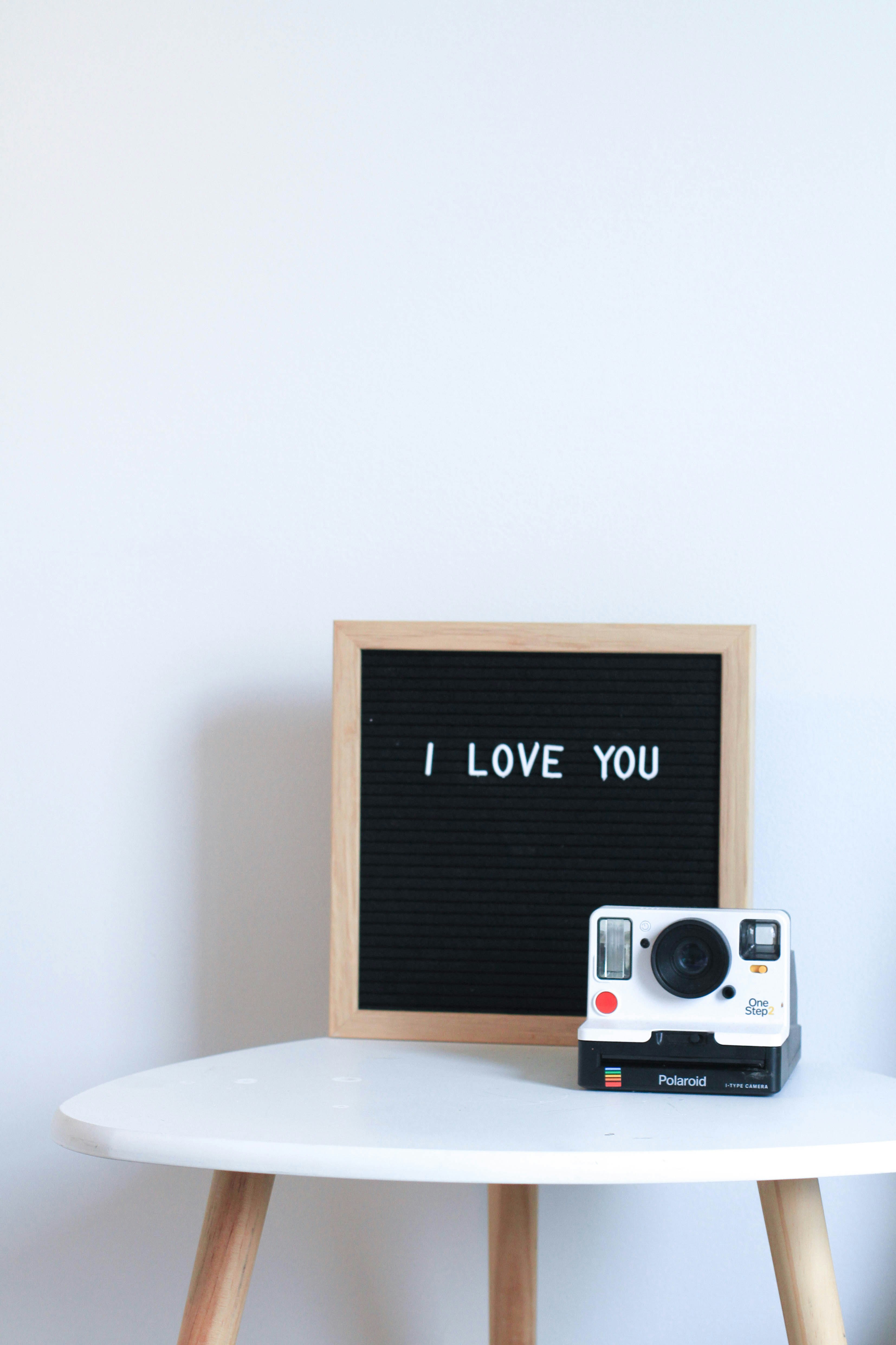 white and black Polaroid instant camera